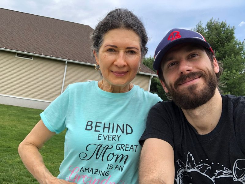 Mark and his mother together outdoors, smiling